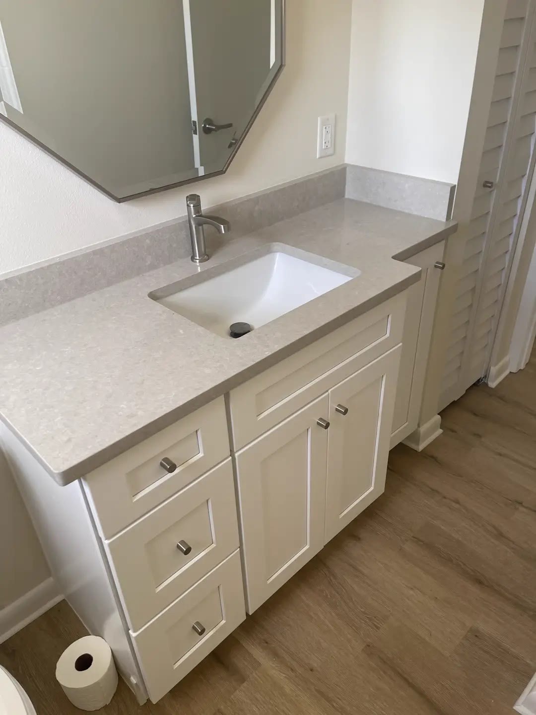 White shaker bathroom vanity with a gray quartz top and undermount sink