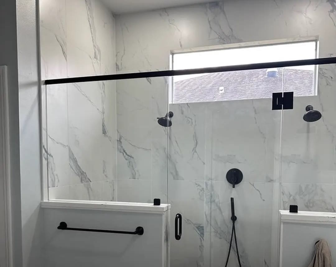Finished walk-in shower with frameless glass, black fixtures and two shower heads