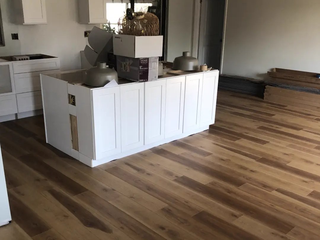 New plank floor installed through a kitchen and living area