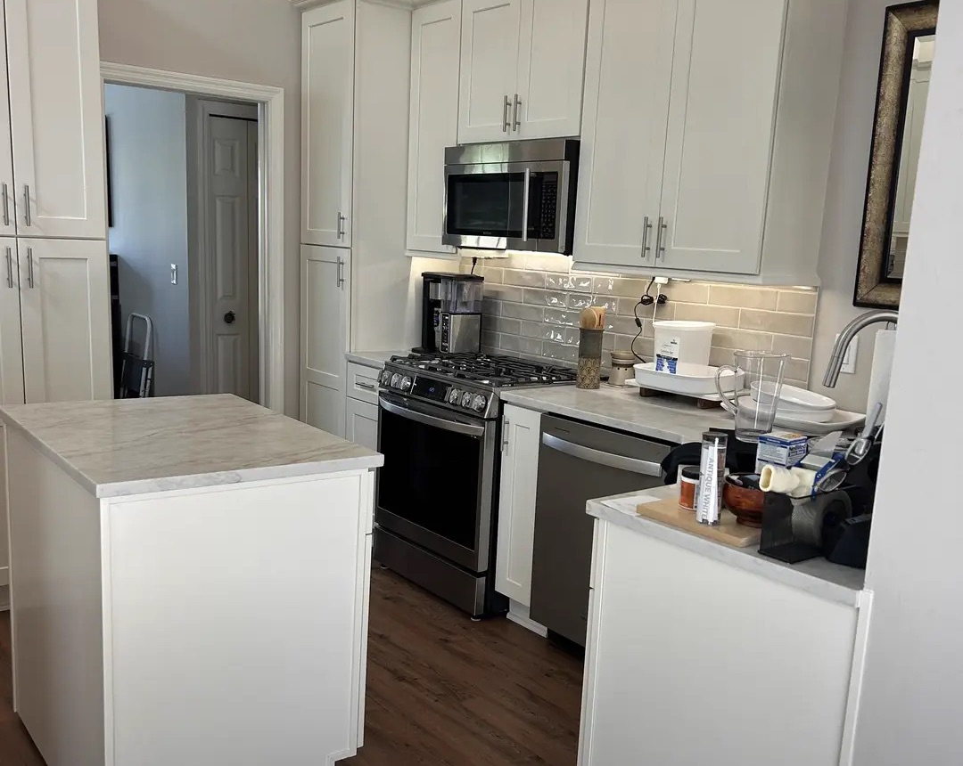 Finished kitchen with prep space between fridge and range