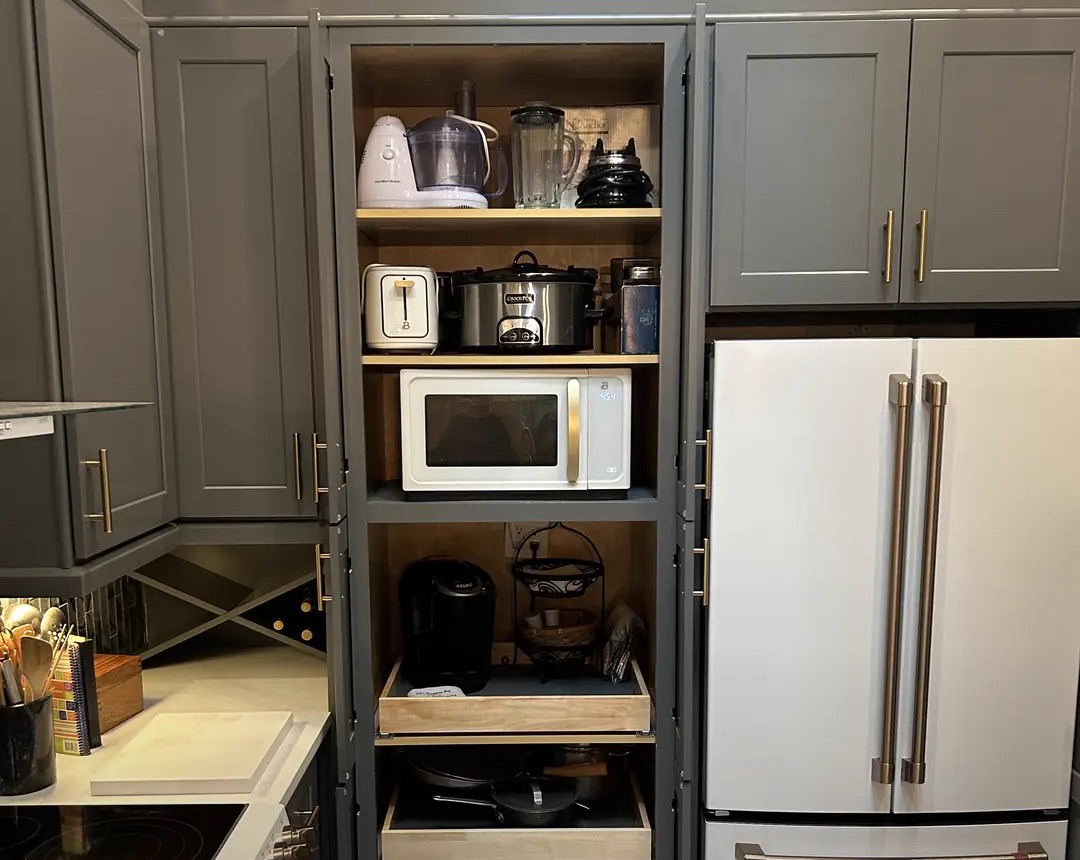 Pantry cabinet with doors that slide back out of the walkway