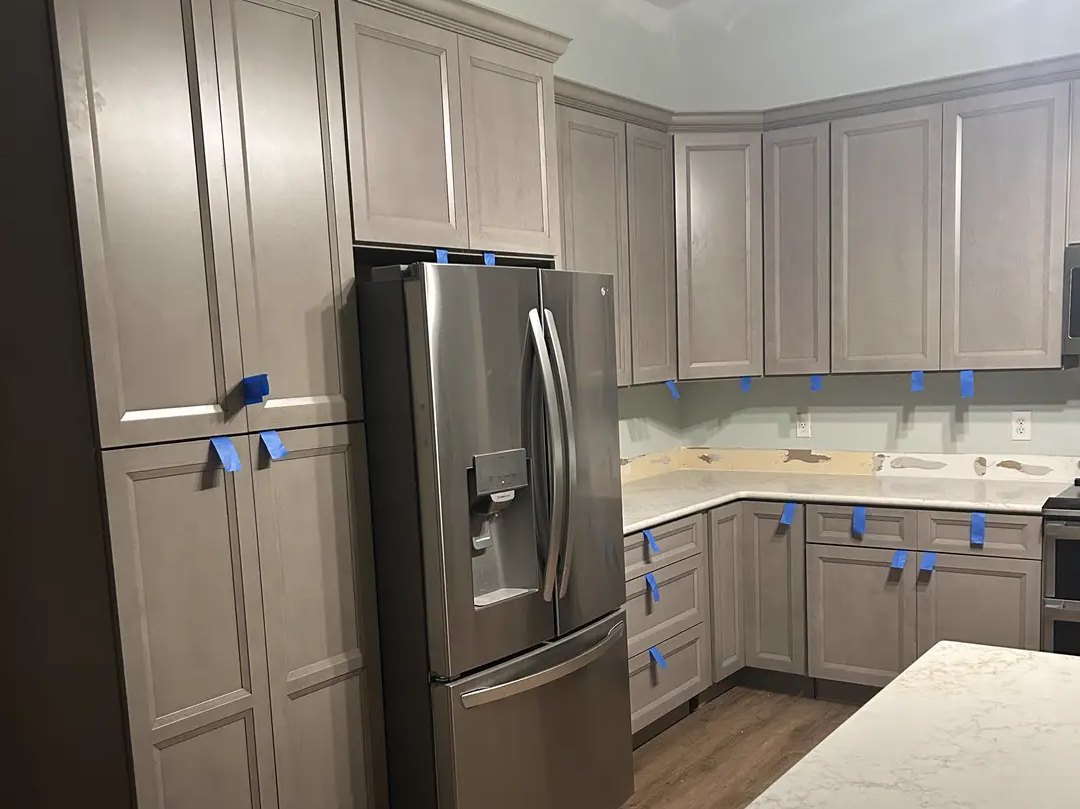 Kitchen with new cabinets and new plank flooring during installation